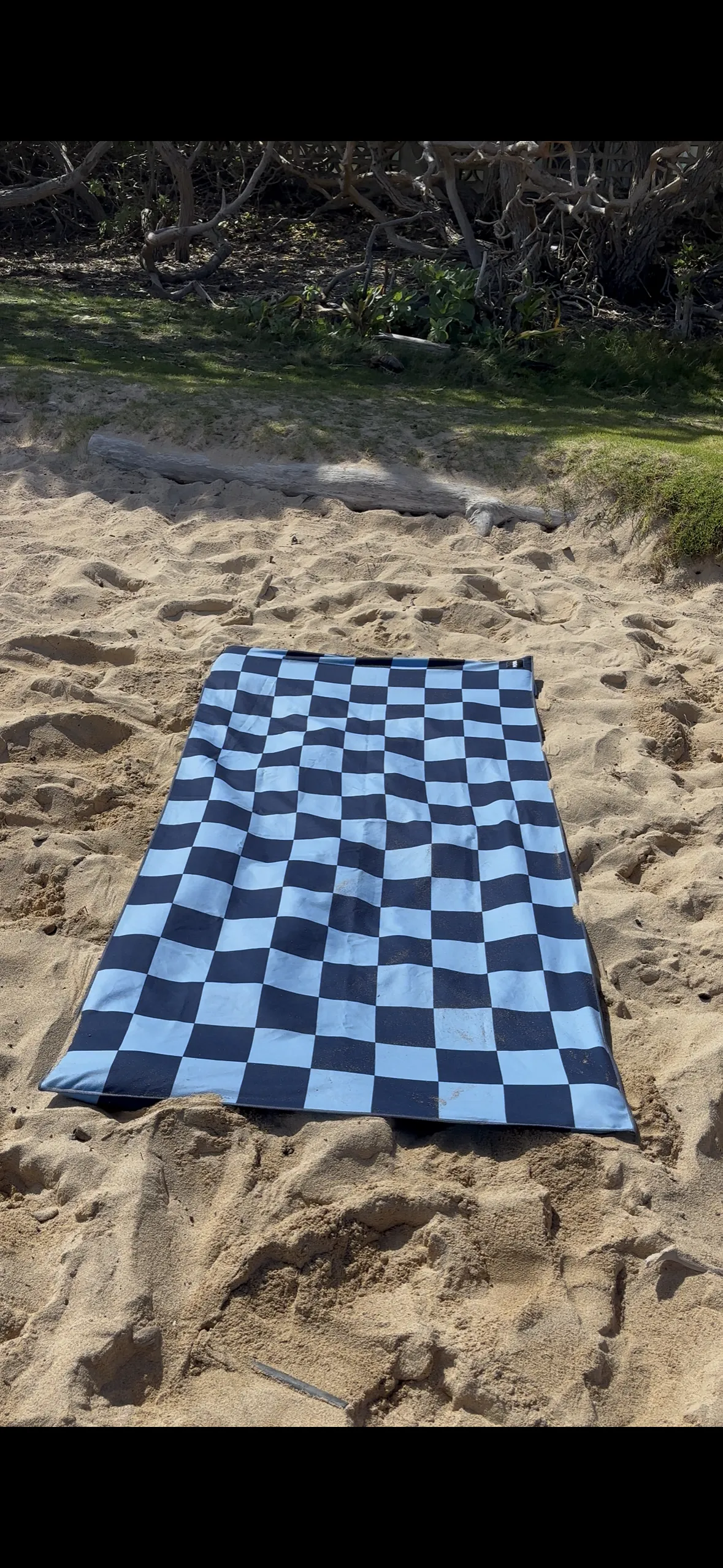 Windy Towel laying flat on the sand